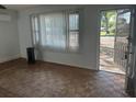 Inviting living room featuring hardwood floors, a window with blinds, and an open entrance at 91 N Triplet Lake Dr, Casselberry, FL 32707