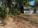 Lush, partially shaded yard showcasing a cozy home exterior with serene, natural surroundings at 91 N Triplet Lake Dr, Casselberry, FL 32707
