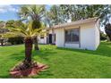 Beautiful single-story home with a green lawn and mature palm trees accenting the exterior at 10665 Whitman Cir, Orlando, FL 32821