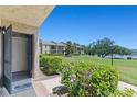 Open front door shows view of expansive lawn with lake view in the distance on a bright day at 1152 Grove St, Maitland, FL 32751