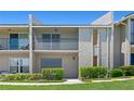 Exterior shot of condo with a screened balcony, muted color scheme, and manicured landscaping at 1152 Grove St, Maitland, FL 32751