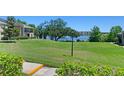 View of the grassy grounds, lake, and neighboring condos, with maintained landscaping at 1152 Grove St, Maitland, FL 32751