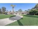 Charming single Gathering home with well maintained front yard and long driveway at 1155 Collins Ave, Orange City, FL 32763