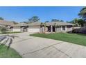 Single Gathering home with two-car garage and palm trees at front at 1155 Collins Ave, Orange City, FL 32763