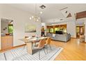 Dining area with hardwood floors, modern lighting, and open floor plan at 1555 Waterwitch Dr, Orlando, FL 32806