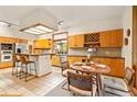Bright kitchen with breakfast bar, stainless steel appliances, and dining area at 1555 Waterwitch Dr, Orlando, FL 32806