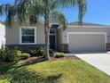 Charming single-Gathering home featuring a well-manicured lawn and a two-car garage at 1711 Penrith Loop, Orlando, FL 32824