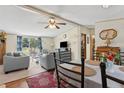 Inviting living room featuring neutral tones, ceiling fan and sliding glass door to backyard at 18600 Old Cheney Hwy, Orlando, FL 32820