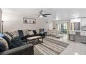 Bright living room featuring an open-concept layout, with tile flooring and views of the kitchen and dining areas at 197 Flame Ave, Maitland, FL 32751