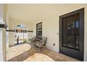 Cozy covered porch with tiled flooring and comfortable seating, perfect for enjoying the outdoors at 2107 Delaney Ave, Orlando, FL 32806