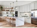 Bright, modern kitchen with a marble island, stainless steel appliances, and sleek, light-colored cabinetry at 22 W Hazel St, Orlando, FL 32804