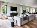 Sun-filled living room featuring hardwood floors, modern furniture, and large windows with backyard views at 22 W Hazel St, Orlando, FL 32804
