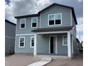 Two-story gray home with multiple windows and covered front porch at 2342 Broadbrook Drive, St Cloud, FL 34771