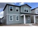 Two-story gray home with multiple windows and covered front porch at 2342 Broadbrook Drive, St Cloud, FL 34771