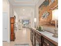 Elegant foyer featuring tile flooring, high ceilings, decorative art, and an open view of the living spaces at 2530 Stargrass Cir, Clermont, FL 34715