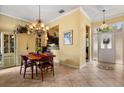 Inviting dining area features a chandelier, tiled floors and views into the kitchen and entryway at 2626 Clarinet Dr, Orlando, FL 32837