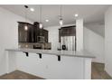 Modern kitchen with stainless steel appliances and a breakfast bar at 2638 Giardino Loop, Kissimmee, FL 34741
