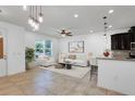 Bright, open-concept living room with tile floors and abundant natural light at 2638 Giardino Loop, Kissimmee, FL 34741