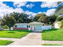 Charming single-story home with a well-maintained lawn and carport at 3024 Sutton Dr, Orlando, FL 32810