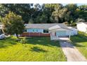 Charming single-story home with a well-maintained lawn and carport at 3024 Sutton Dr, Orlando, FL 32810