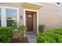 Inviting front entrance featuring a decorative wreath and well-maintained landscaping at 335 Merry Brook Cir, Sanford, FL 32771