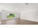 Minimalist living room showcasing natural light, sleek floors, and a clean, modern aesthetic at 340 Irving Bend Dr, Groveland, FL 34736