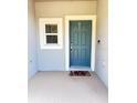 Inviting entryway with a stylish teal door, a small window for natural light, and a decorative welcome mat at 3623 Main Harbor Dr, Kissimmee, FL 34746