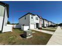 View of townhouse featuring neutral siding, a driveway, and a small front yard at 366 Madison Dr, Davenport, FL 33837