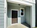 Close-up of the home's entrance featuring a dark door and exterior lighting at 366 Madison Dr, Davenport, FL 33837