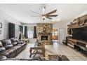 Spacious living room features stone fireplace, ceiling fan and tile flooring at 387 Kantor Blvd, Casselberry, FL 32707