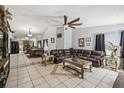 Open-concept living room with tile flooring, dining area and large windows at 387 Kantor Blvd, Casselberry, FL 32707