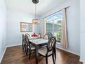 Elegant dining room featuring a glass-top table, stylish chairs, and a decorative chandelier at 4008 Lakeside Reserve Ct, Orlando, FL 32810