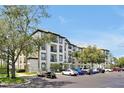 Exterior view of a condo complex showcasing multiple levels and ample parking space at 4126 Breakview Dr # 40901, Orlando, FL 32819
