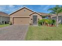 Charming single-story home with brick driveway, well-maintained lawn, and mature palm tree at 424 Lazio Cir, Debary, FL 32713