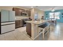 Bright kitchen featuring granite countertops, a spacious island, and stainless steel appliances at 424 Lazio Cir, Debary, FL 32713