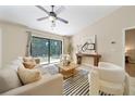 Bright living room with large sliding glass doors, contemporary furniture, and stylish decor at 510 N Leavitt Ave, Orange City, FL 32763