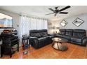 Cozy living room featuring comfortable leather seating and a ceiling fan at 525 E Foothill Way, Casselberry, FL 32707