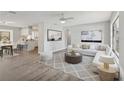 Bright living room with gray-toned walls, white furniture, and an open floor plan at 525 Legume Dr, Port Orange, FL 32127