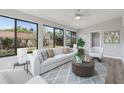Inviting living room filled with natural light from large windows overlooking the backyard at 525 Legume Dr, Port Orange, FL 32127