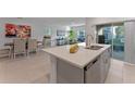 Open-concept kitchen with an island, stainless steel appliances, and a view into the dining and living areas at 543 Pine Tree Bridge Trl, St Cloud, FL 34772