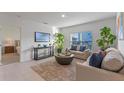 Cozy living room with natural light, neutral decor, and an adjacent view into the main bedroom at 543 Pine Tree Bridge Trl, St Cloud, FL 34772