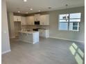 Spacious kitchen with a center island, stainless steel appliances, tile floors, and open dining area at 620 Pothos St, Apopka, FL 32703