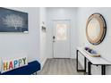 Bright foyer features elegant decor, stylish mirror, and a welcoming atmosphere at 7803 Laurel Oak Ln, Kissimmee, FL 34747