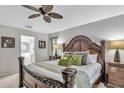 Elegant primary bedroom boasts a decorative wood bed frame, providing comfort and style with an en-suite bath at 8471 Secret Key Cv, Kissimmee, FL 34747