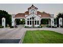 A gated community entrance with Mediterranean architecture, security, and manicured landscaping at 8761 The Esplanade # 6, Orlando, FL 32836