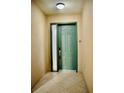 A private entryway with a green door and modern smart lock at 8761 The Esplanade # 6, Orlando, FL 32836