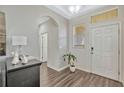 Welcoming foyer featuring wood floors, high ceilings, and neutral decor at 9456 Komika Ln, Winter Garden, FL 34787