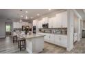 Stylish kitchen with granite countertops, a large island, stainless steel appliances, and sleek white cabinetry at Tbd Royal Trails Rd, Eustis, FL 32736
