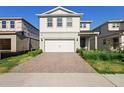 Charming two-story home with a brick driveway and lush landscaping at 10215 Park Estates Ave, Orlando, FL 32836