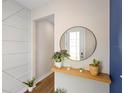 Bright foyer featuring wood-look floors and decorative accent wall at 10215 Park Estates Ave, Orlando, FL 32836